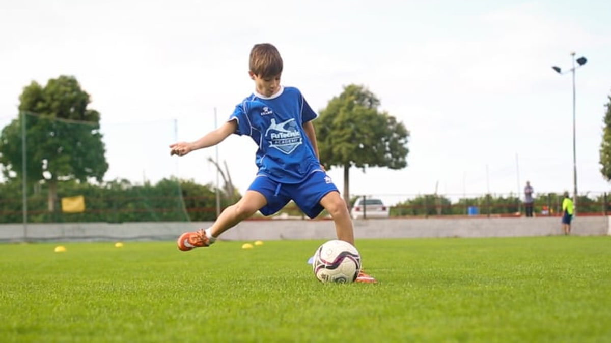 Player striking a ball on the pitch